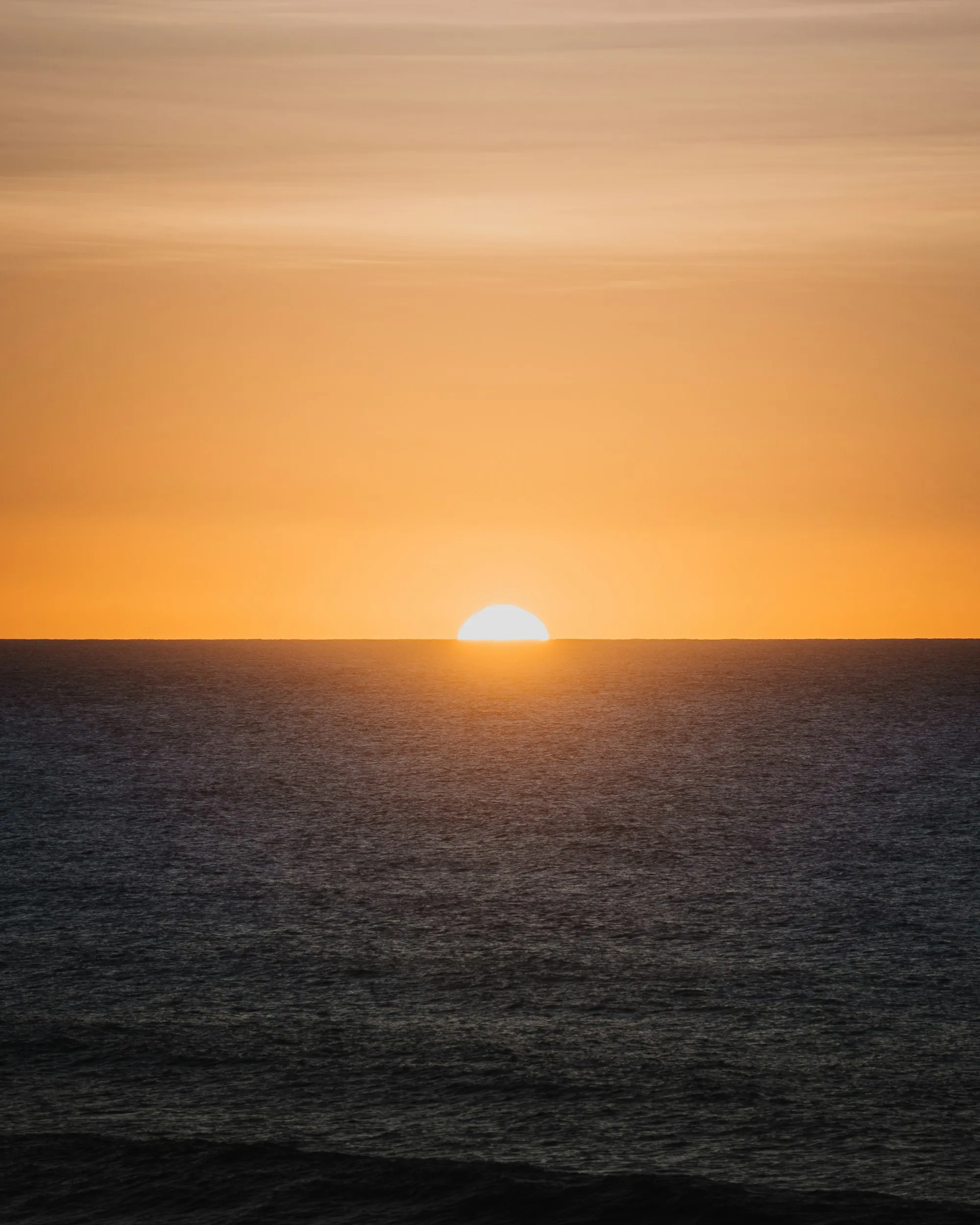 Sun setting over the Atlantic on a cloudy evening in Imsouane