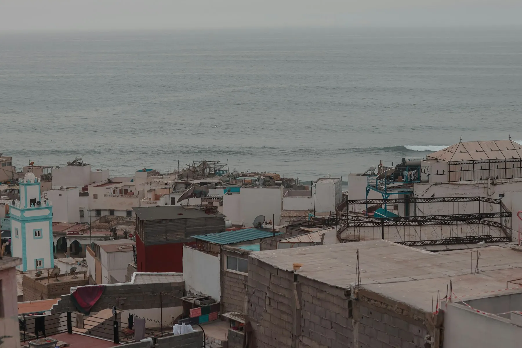 White-washed coastal village above the surf in Taghazout