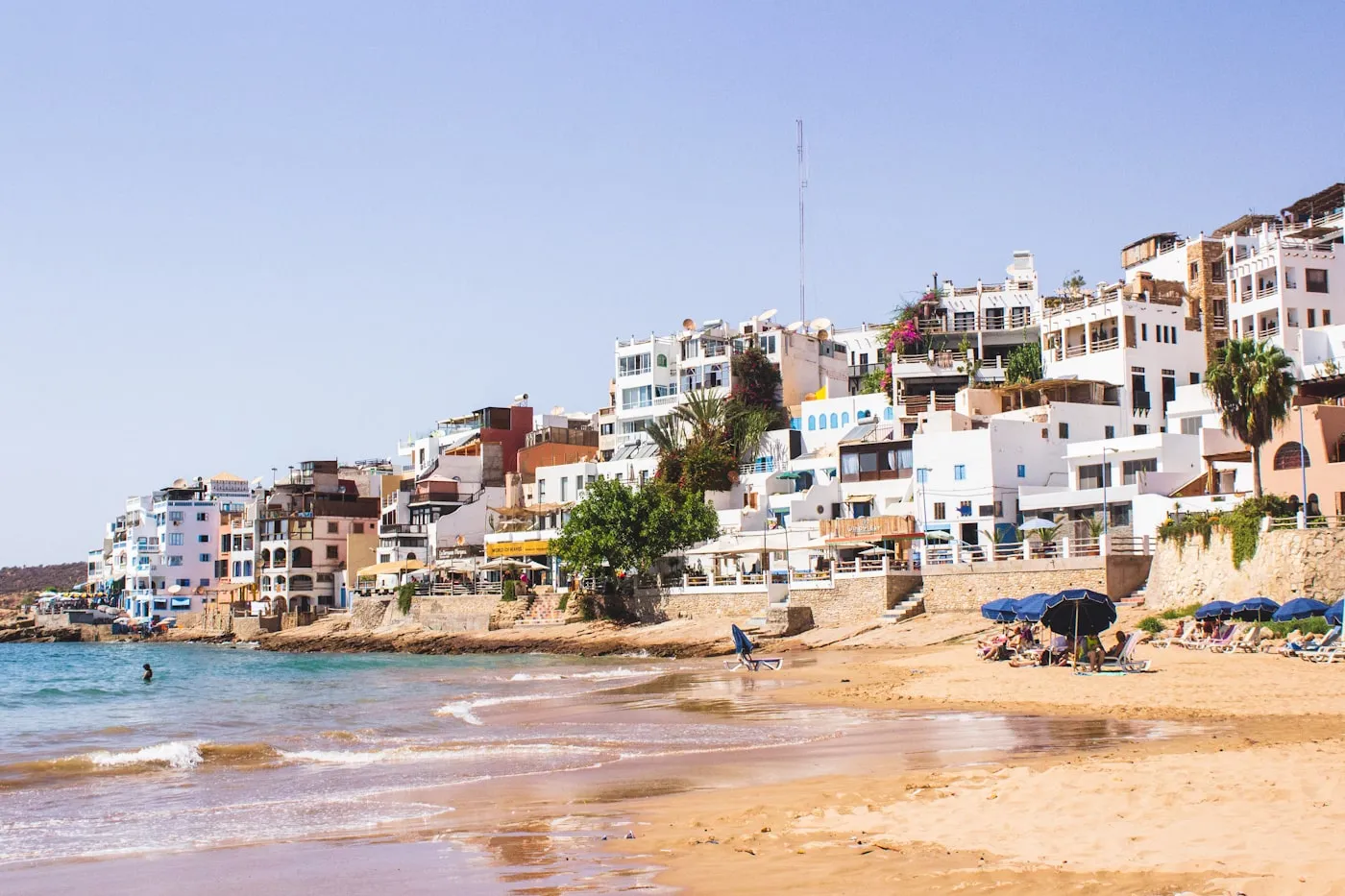 White building above the sand and sea in Taghazout
